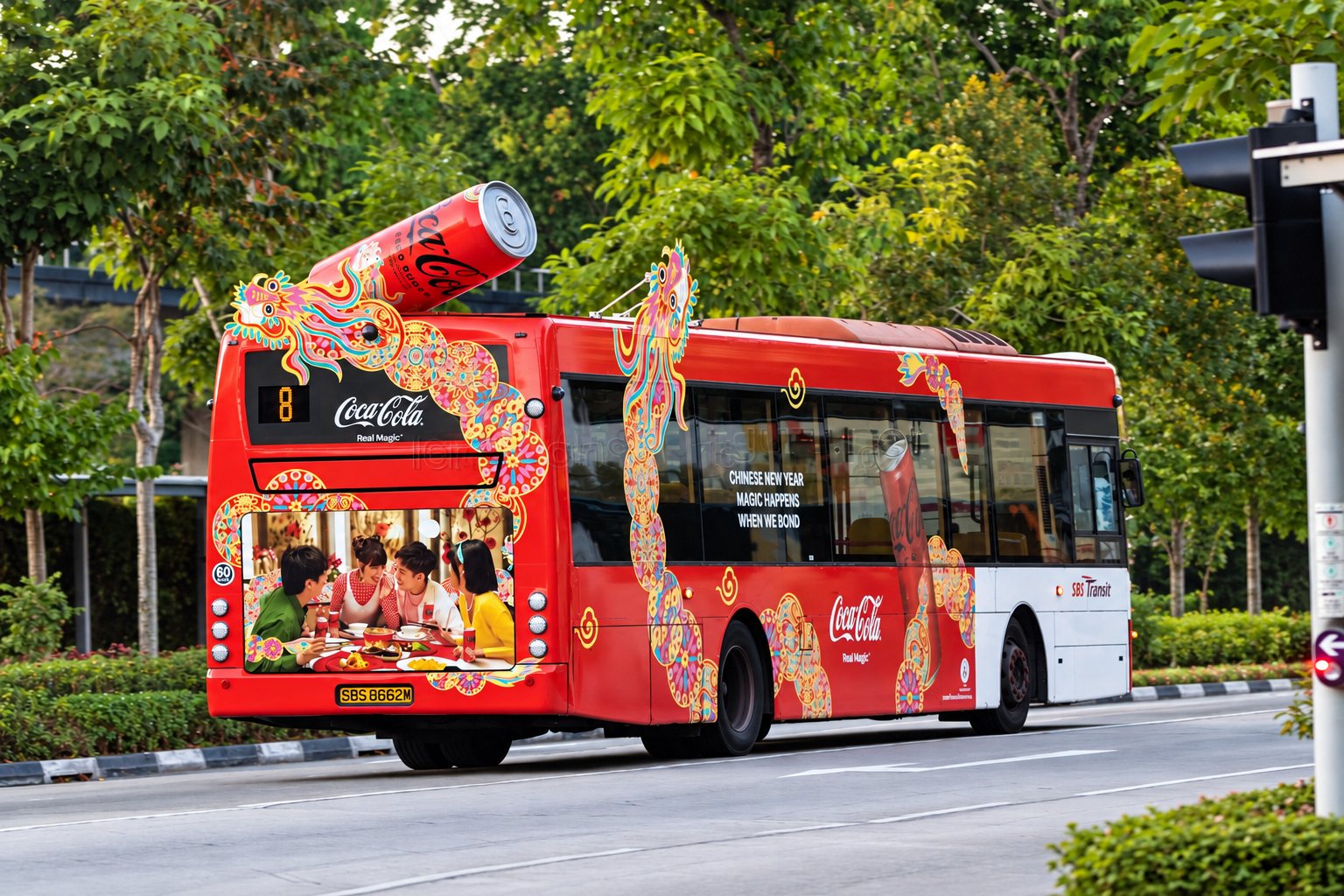 Coca-Cola Chinese New Year bus transit wrap, rear close-up of the illuminated dragon artwork on a moving bus
