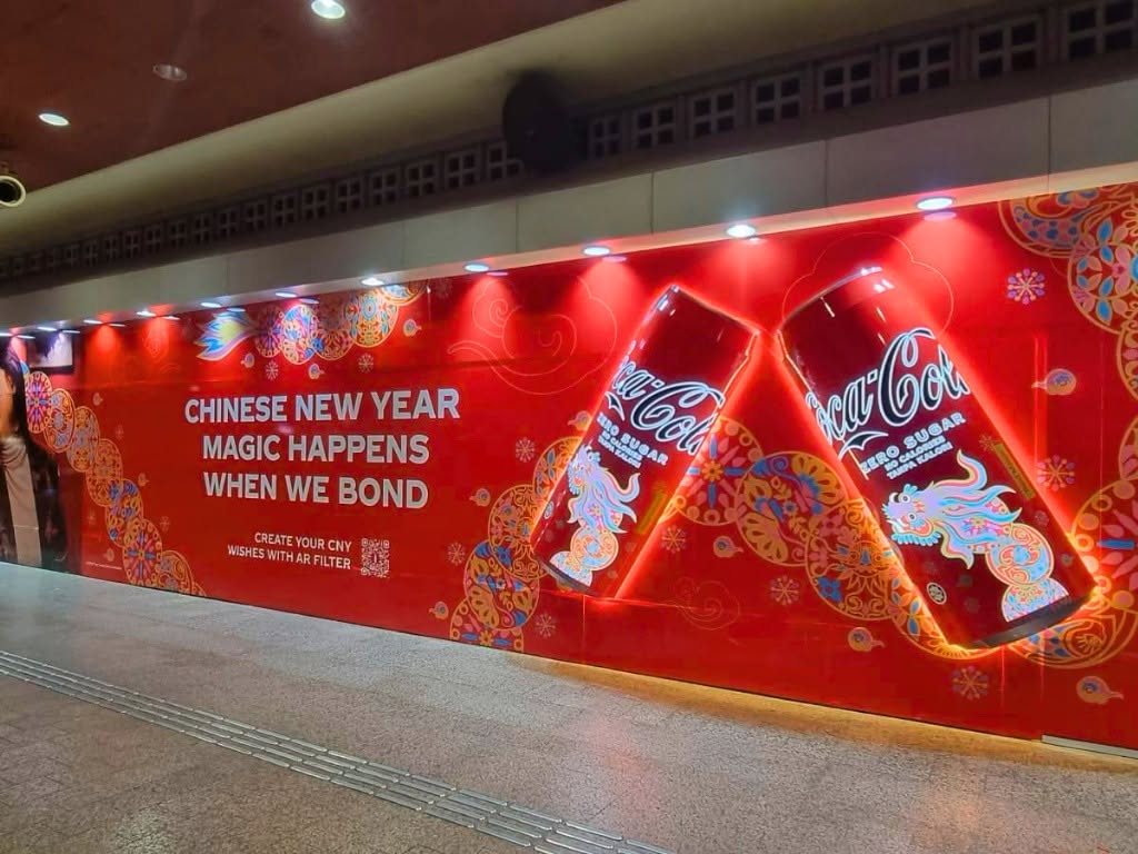 Coca-Cola Chinese New Year MRT station wall decal, illuminated 3D die-cut Coca-Cola cans with a dragon motif and QR code for the AR filter tie-in